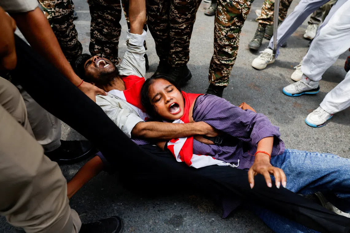 Protesters are detained by security personnel during a protest by the Cockroach Janta Party (CJP) seeking the resignation of India's Chief Election Commissioner Gyanesh Kumar, near the protest site in New Delhi, India, October 11, 2026. REUTERS/Adnan Abidi TPX IMAGES OF THE DAY
