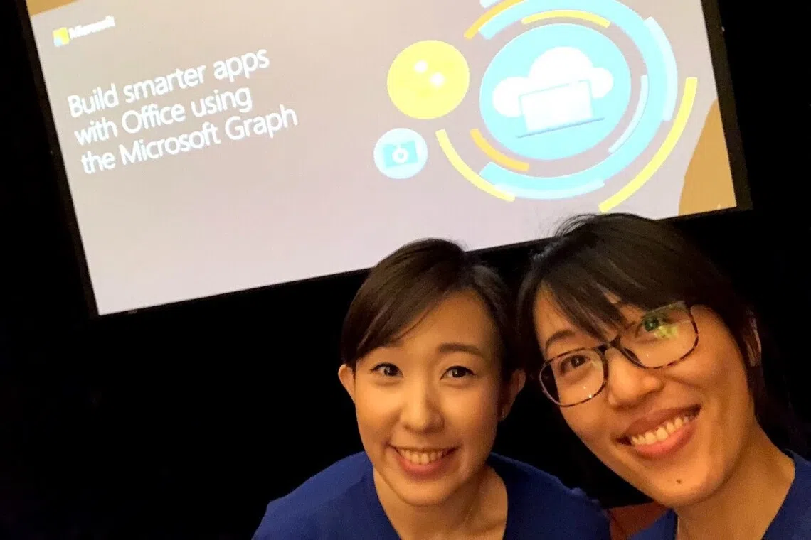 ang jun jia, right, with colleague in tech job in microsoft as technical account manager after career change into tech role
