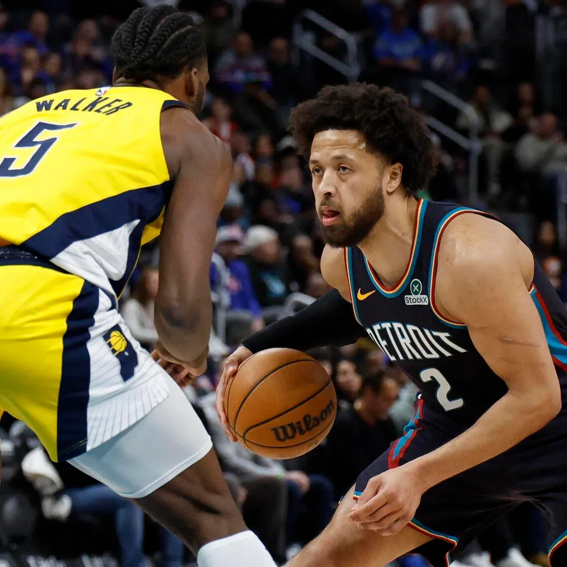 Jan 17, 2026; Detroit, Michigan, USA;  Detroit Pistons guard Cade Cunningham (2) dribbles defended by Indiana Pacers forward Jarace Walker (5) in the first half at Little Caesars Arena. Mandatory Credit: Rick Osentoski-Imagn Images