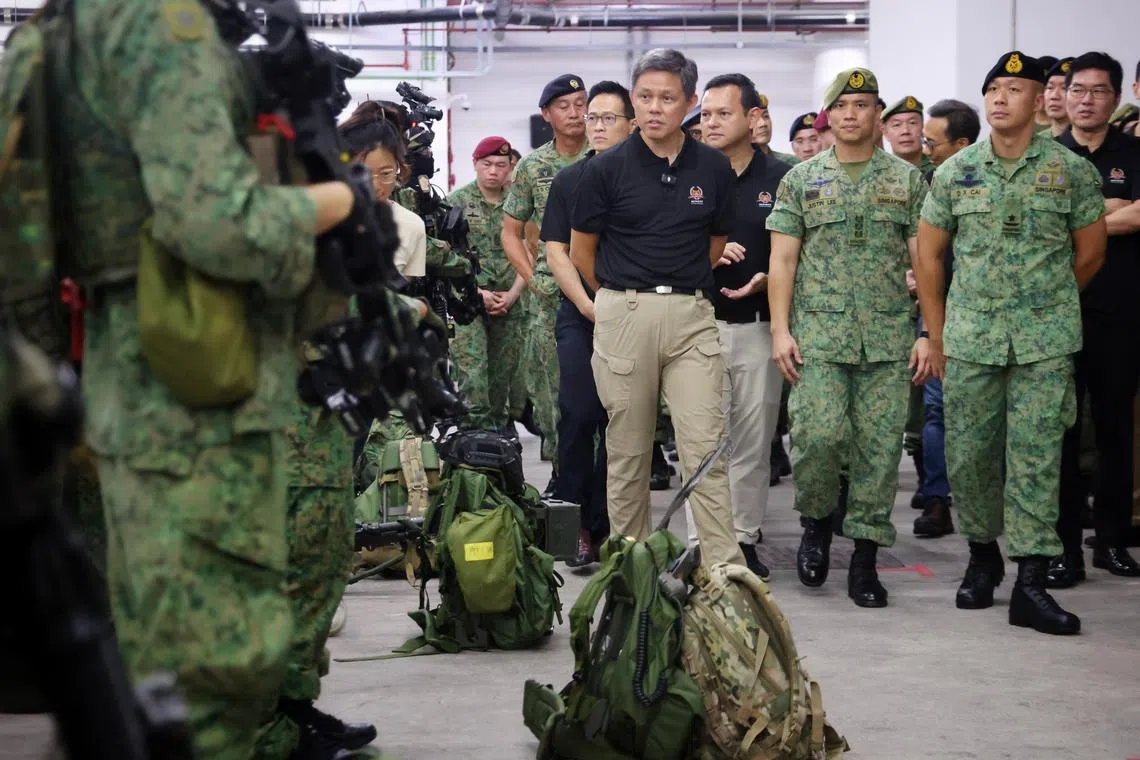 Defence Minister Chan Chun Sing, alongside Minister of State for Defence Desmond Choo and Senior Minister of State Zaqy Mohamad, meeting ADF troopers at Nee Soon Camp on May 27, 2025. ST PHOTO: JASON QUAH