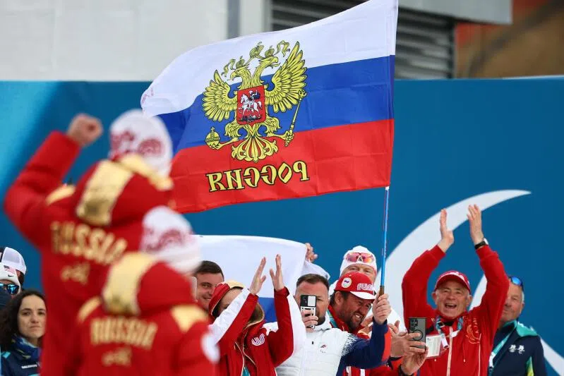 Fans with the flag of Russia are pictured ahead of the victory ceremony at the Milano Cortina 2026 Paralympics event.