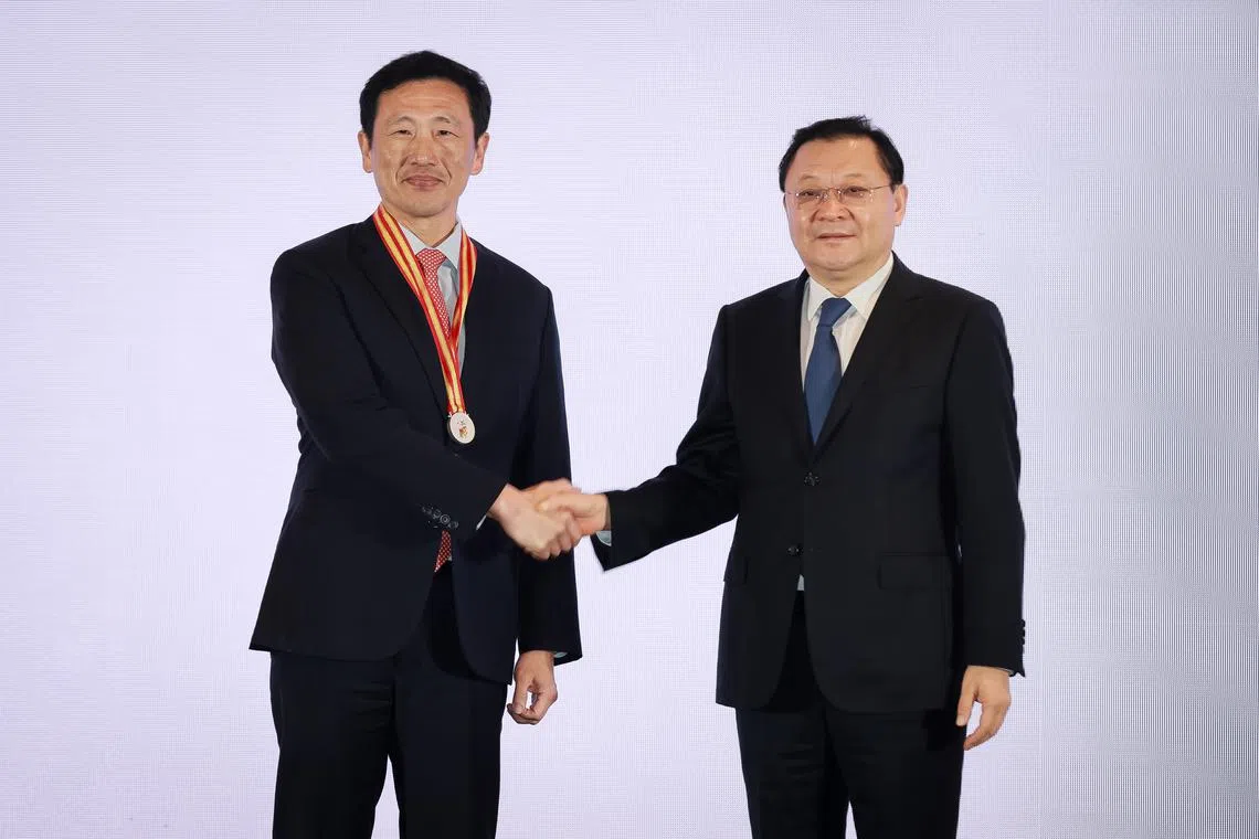 Guangdong Governor Wang Weizhong presenting the Guangdong Friendship Award to Health Minister Ong Ye Kung at the 13th Singapore-Guangdong Collaboration Council meeting on June 26.
