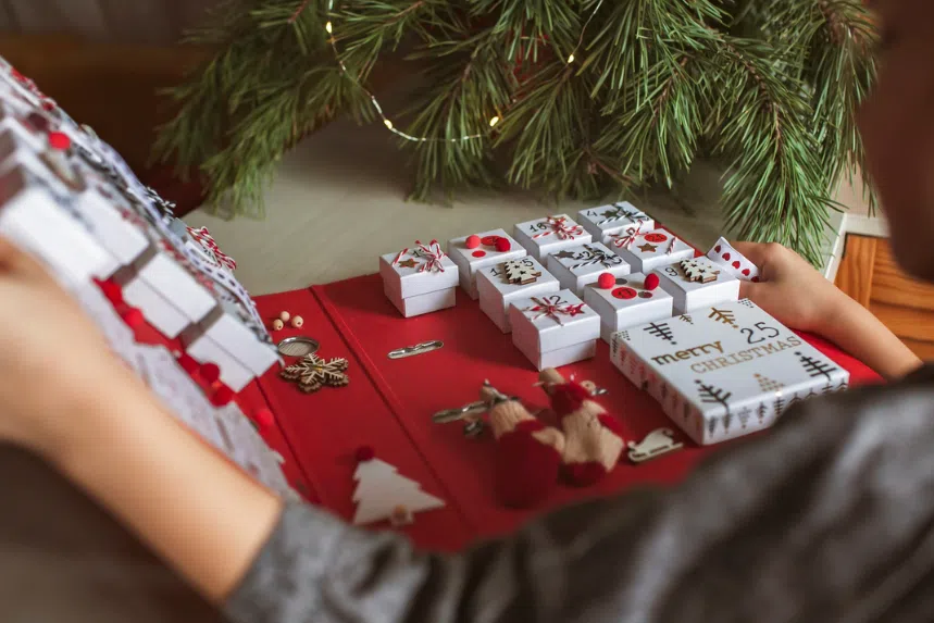 Child flipping open advent calendar during Christmas 
