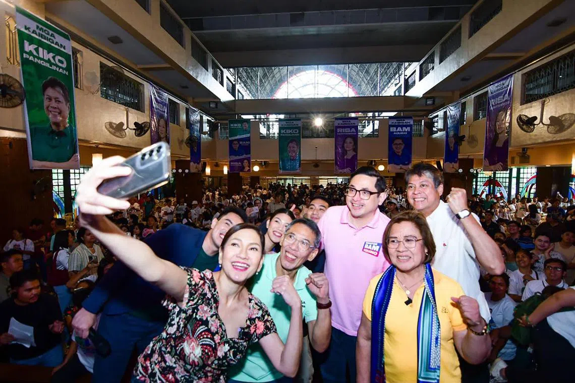 Senator Risa Hontiveros (1st left, holding phone) takes a selfie on the campaign trail with human rights lawyers and House lawmaker candidates Chel Diokno (2nd from left) and Leila de Lima (3rd from left) as well as senatorial bets Bam Aquino (2nd from right) and Kiko Pangilinan (3rd from right) in May 2025. 
