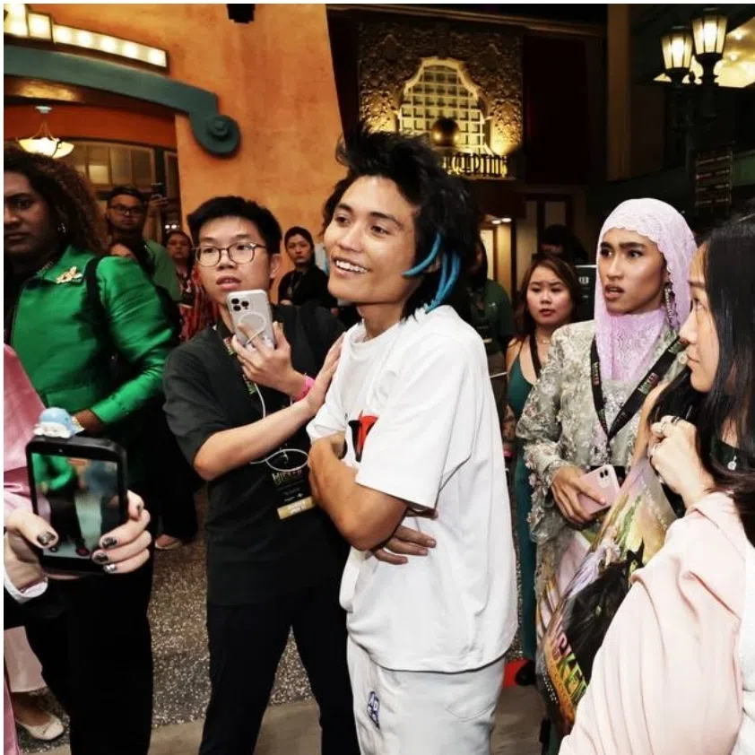 Johnson Wen (left), 26, is accused of committing the offence at the Universal Studios Singapore on Nov 13. Ariana Grande (right) seen being comforted by her co-star Cynthia Erivo after the incident.