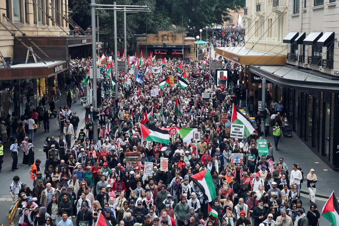Demonstrators hold placards as they take part in the 'Nationwide March for Palestine' protest in Sydney, Australia, August 24, 2025. REUTERS/Hollie Adams