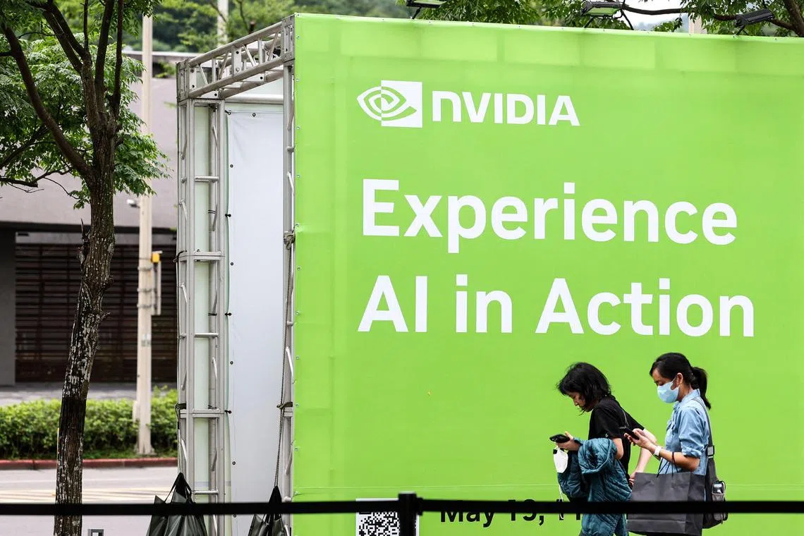 (FILES) People walk past a Nvidia advertisement board at the Taipei Music Center in Taipei on May 19, 2025, where Nvidia co-founder and CEO Jensen Huang delivered the first keynote speech of Computex 2025. Chinese authorities summoned US technology giant Nvidia on July 31, 2025 to discuss "serious security issues" discovered involving its chips, the country's top internet regulator said. (Photo by I-Hwa Cheng / AFP)