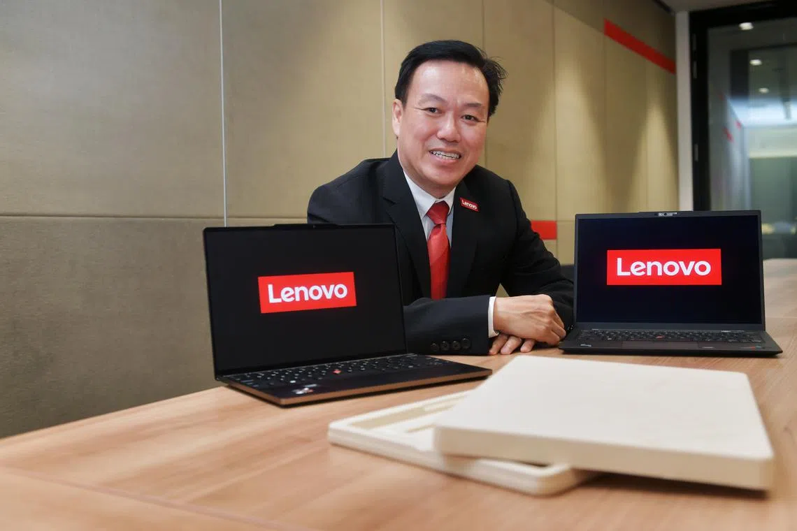 Lenovo General manager Nigel Lee with Lenovo laptops and their eco packaging.