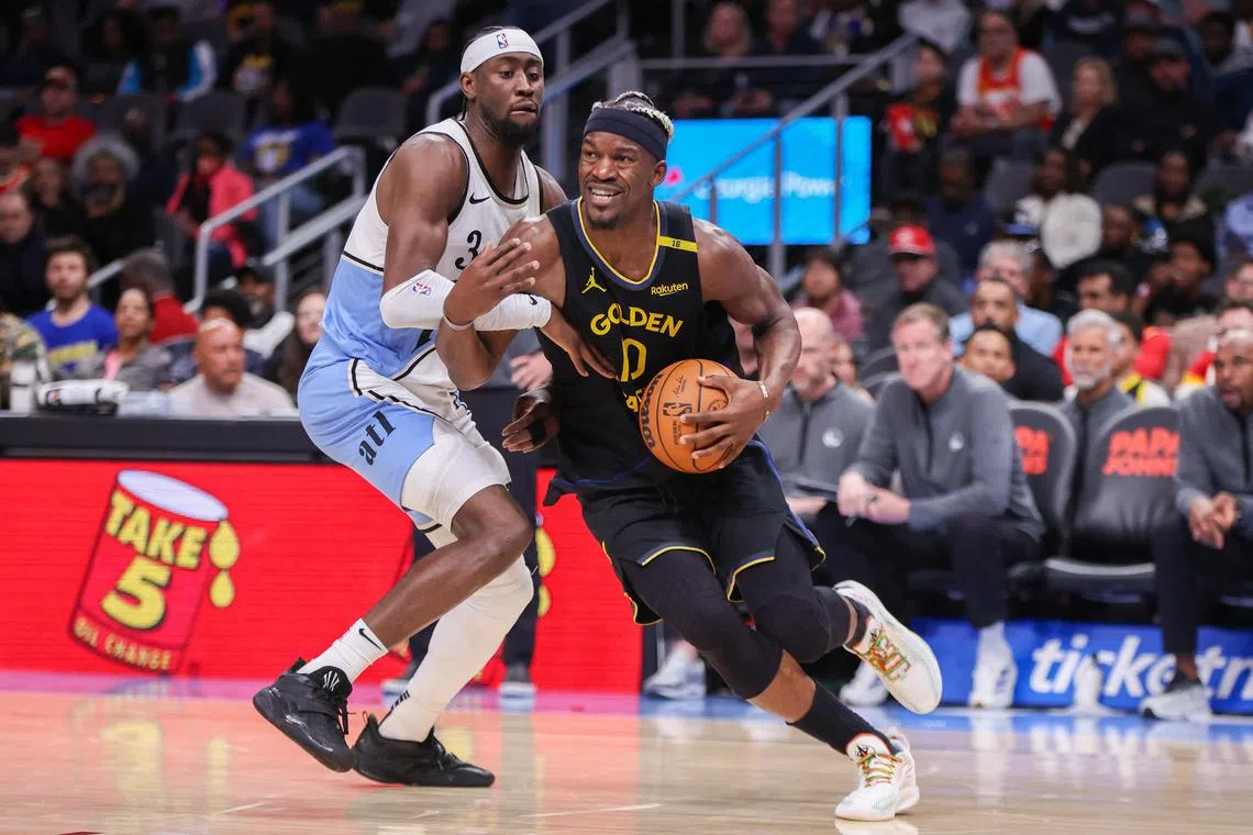 Mar 22, 2025; Atlanta, Georgia, USA; Golden State Warriors forward Jimmy Butler III (10) drives past Atlanta Hawks guard Caris LeVert (3) in the fourth quarter at State Farm Arena. Mandatory Credit: Brett Davis-Imagn Images
