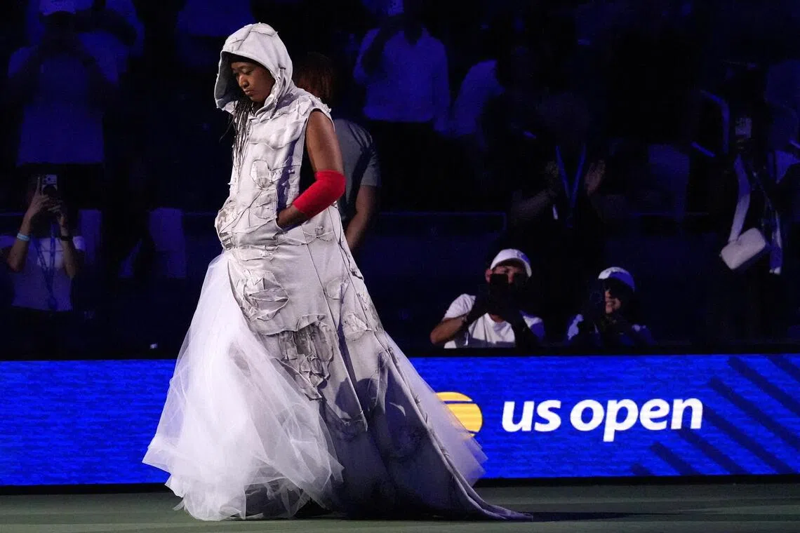 Naomi Osaka arrived at the US Open on Aug 31  in a hooded tunic featuring patchwork-style panels adorned with press clippings from past events.