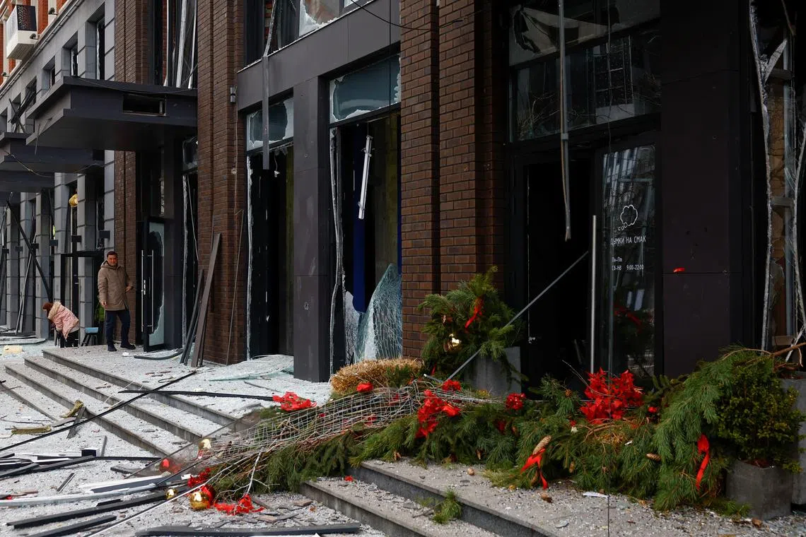 A person looks at a damaged Christmas tree after a Russian missile strike, amid Russia's attack on Ukraine, in central Kyiv, Ukraine on Dec 20.