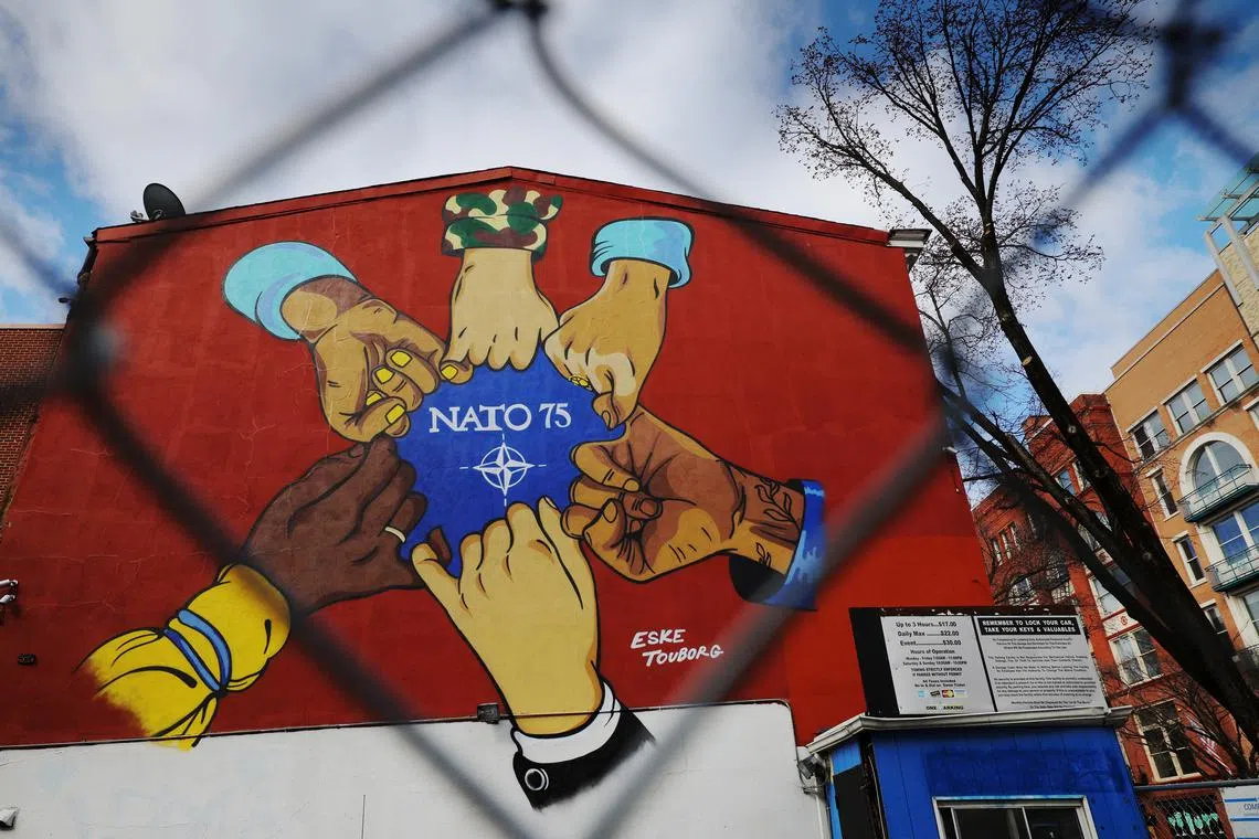 An artwork celebrating the 75th anniversary of NATO in 2024 is painted on the wall behind a chain link fence in Washington, DC, U.S., March 6, 2025.   REUTERS/Brian Snyder