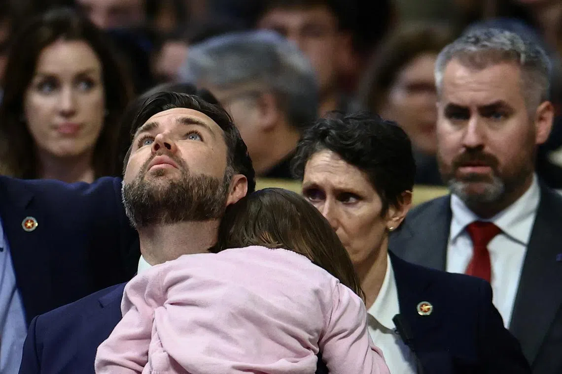 U.S. Vice President J.D. Vance looks up during the Good Friday Passion of the Lord service while holding his daughter in Saint Peter's Basilica at the Vatican, April 18, 2025. REUTERS/Yara Nardi