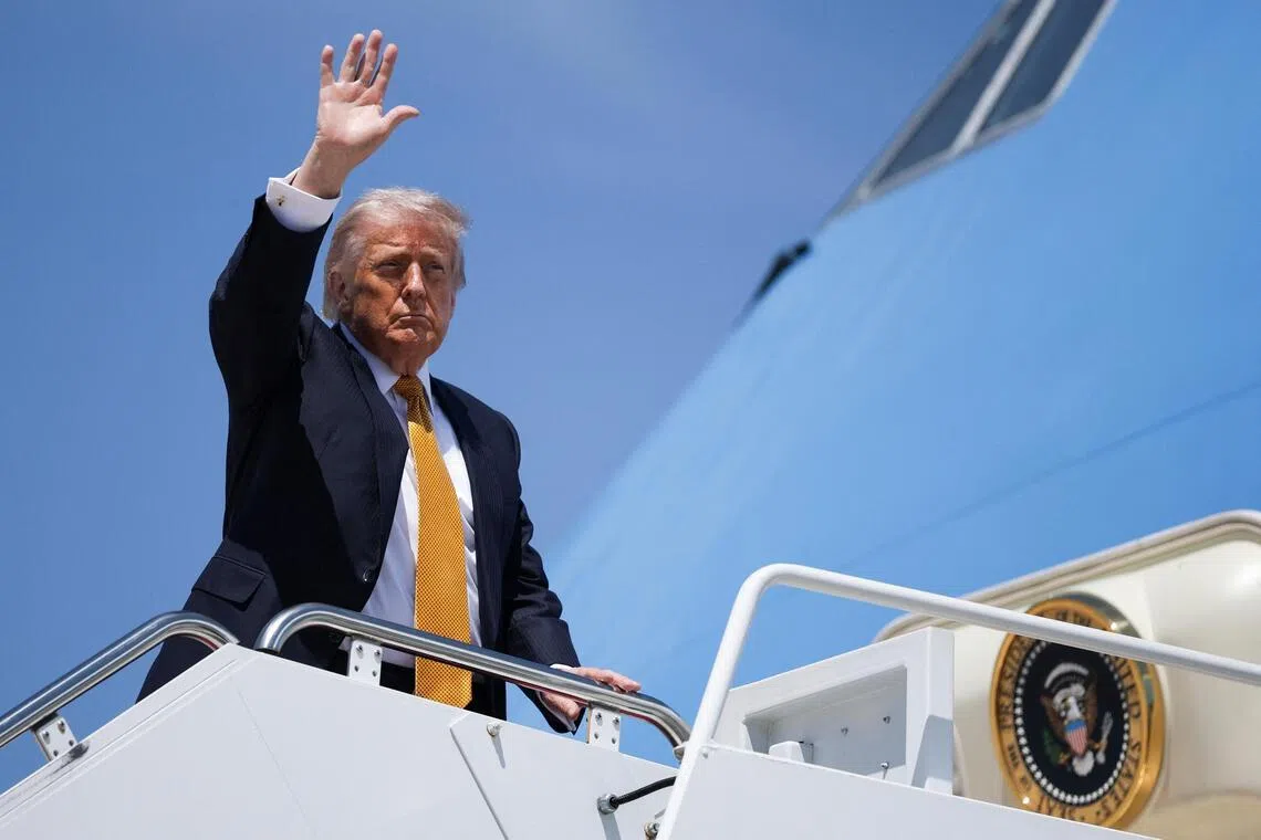 US President Donald Trump waves as he boards Air Force One, bound for China, on May 12.