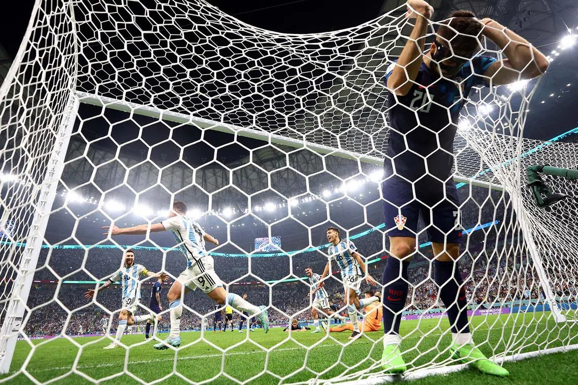 Soccer Football - FIFA World Cup Qatar 2022 - Semi Final - Argentina v Croatia - Lusail Stadium, Lusail, Qatar - December 13, 2022 Argentina's Julian Alvarez celebrates scoring their second goal with Lionel Messi, Rodrigo De Paul and Nahuel Molina as Croatia's Josko Gvardiol, Dominik Livakovic and Borna Sosa look dejected REUTERS/Carl Recine TPX IMAGES OF THE DAY