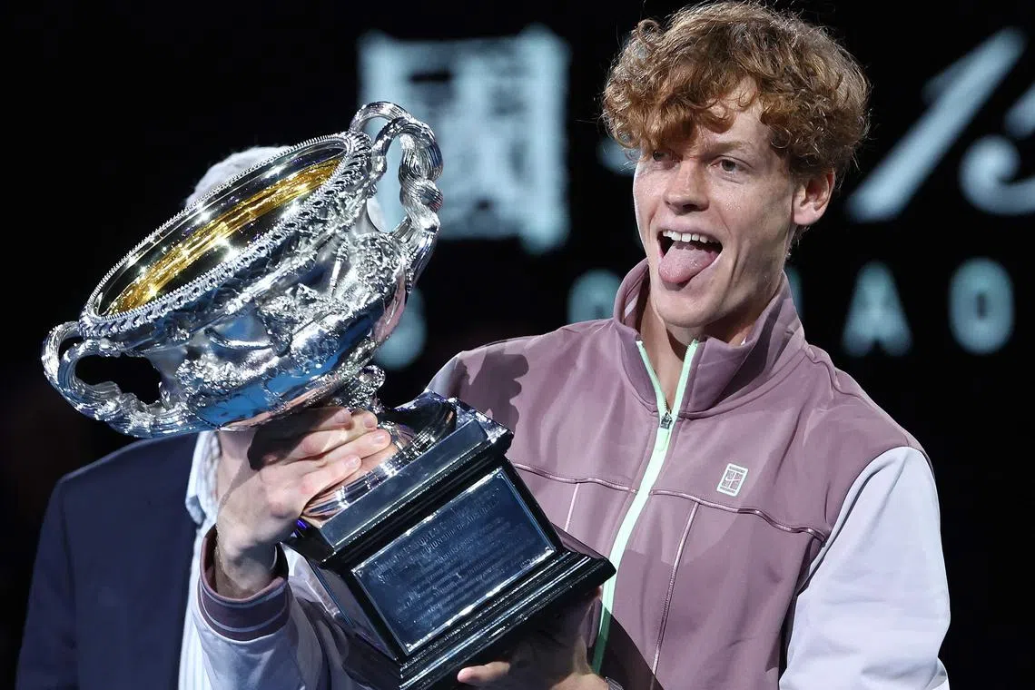 Italy's Jannik Sinner celebrating with the Norman Brookes Challenge Cup trophy after defeating Russia's Daniil Medvedev 3-6, 3-6, 6-4, 6-4, 6-3 in the men's singles final match on day 15 of the Australian Open tennis tournament in Melbourne on Jan 26.