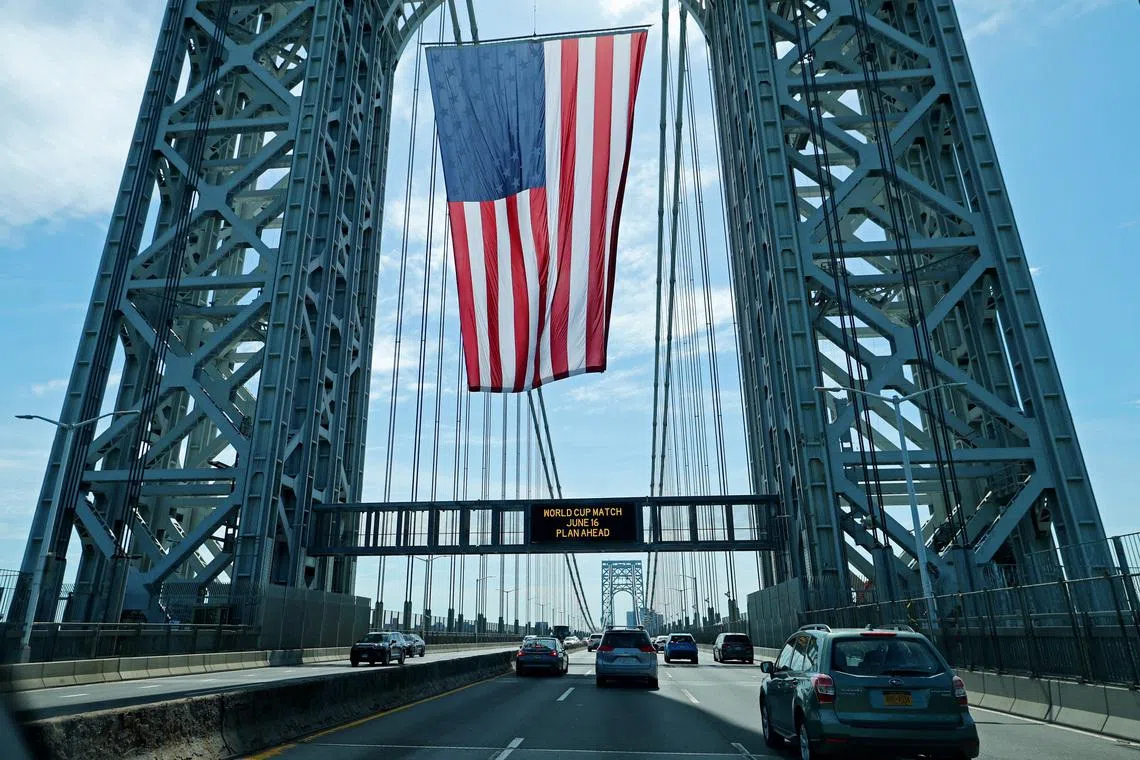 Soccer Football - FIFA World Cup 2026 - Group E - Ivory Coast v Ecuador - New Jersey, U.S. - June 14, 2026 A United States national flag hangs on the George Washington bridge between New Jersey and New York ahead of the match REUTERS/Mike Segar