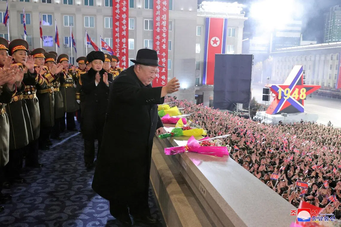 North Korean leader Kim Jong Un greets the crowd during a military parade on Feb 8, 2023.