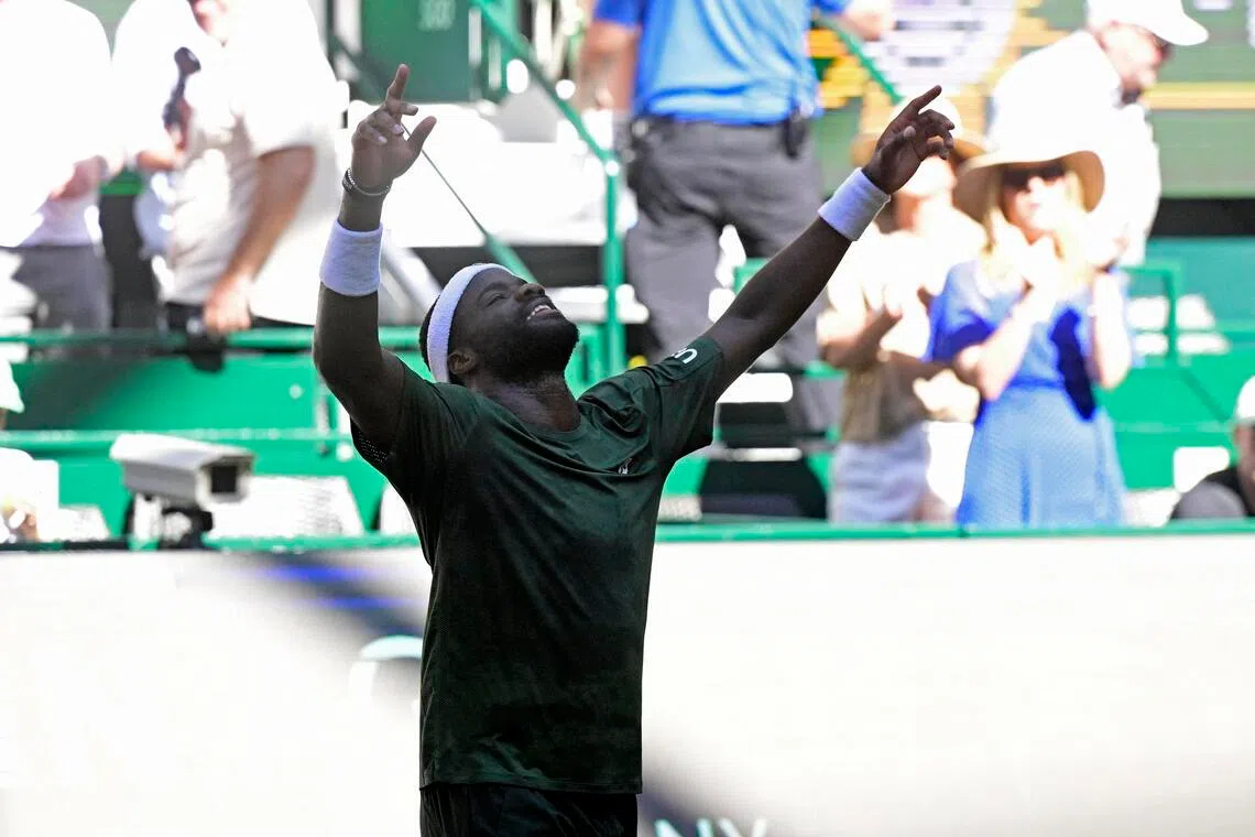 Frances Tiafoe of the US celebrates after countryman Taylor Fritz in the Halle Open final at the OWL Arena in Germany on June 21, 2026.
