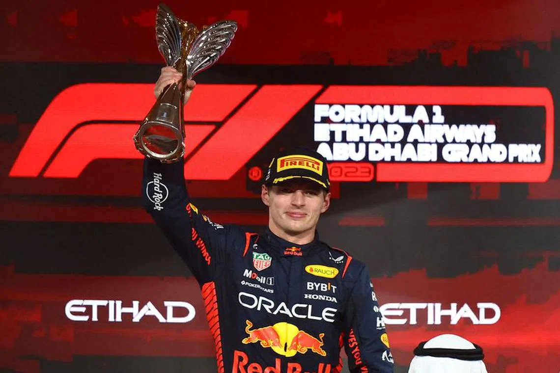 FILE PHOTO: Formula One F1 - Abu Dhabi Grand Prix - Yas Marina Circuit, Abu Dhabi, United Arab Emirates - November 26, 2023 Red Bull's Max Verstappen celebrates with the trophy on the podium after winning the race REUTERS/Rula Rouhana