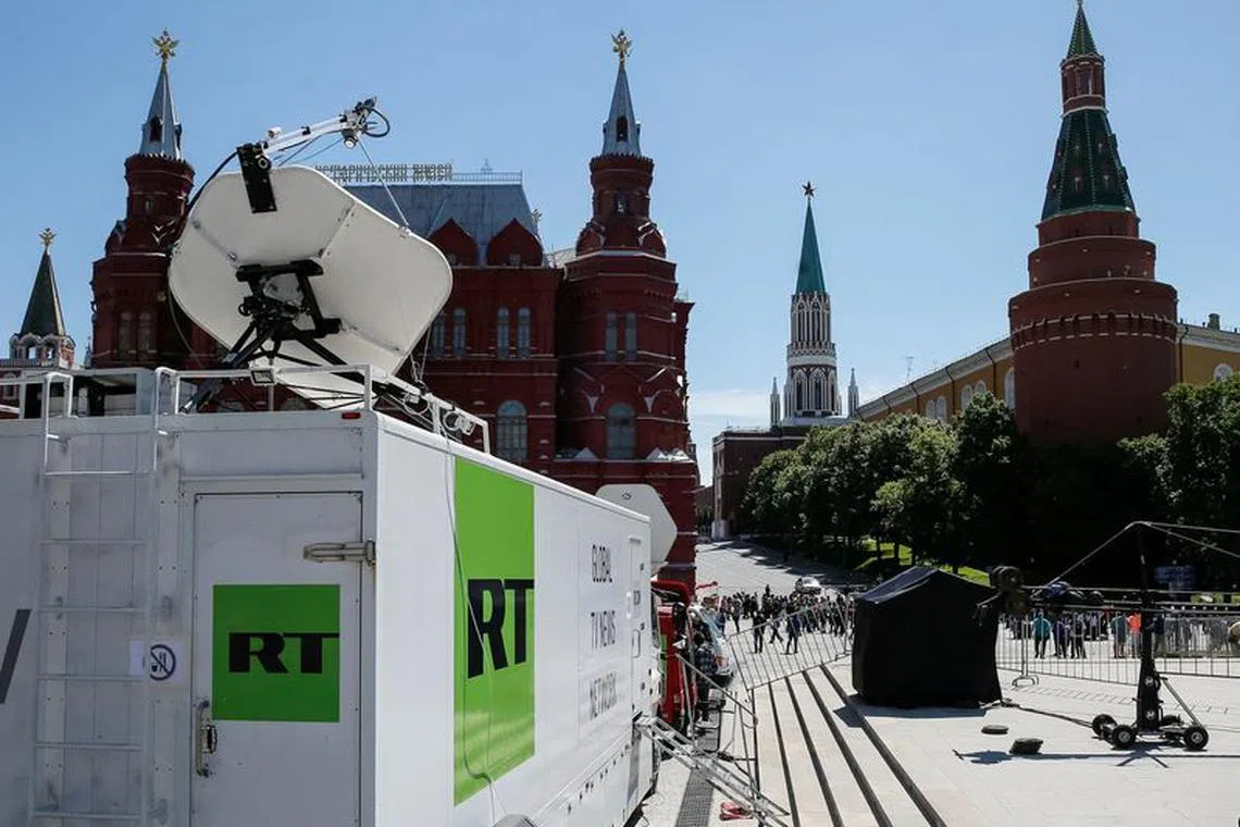 FILE PHOTO: Vehicles of Russian state-controlled broadcaster Russia Today (RT) are seen near the Red Square in central Moscow, Russia June 15, 2018. Picture taken June 15, 2018.  REUTERS/Gleb Garanich/File Photo