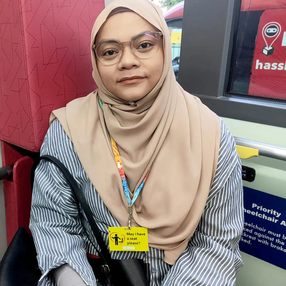 Ms Ratnah Hafizah, who has multiple sclerosis, said bringing along a May I Have a Seat Please card has given her the confidence to take a priority seat on the bus without the fear of judgement.