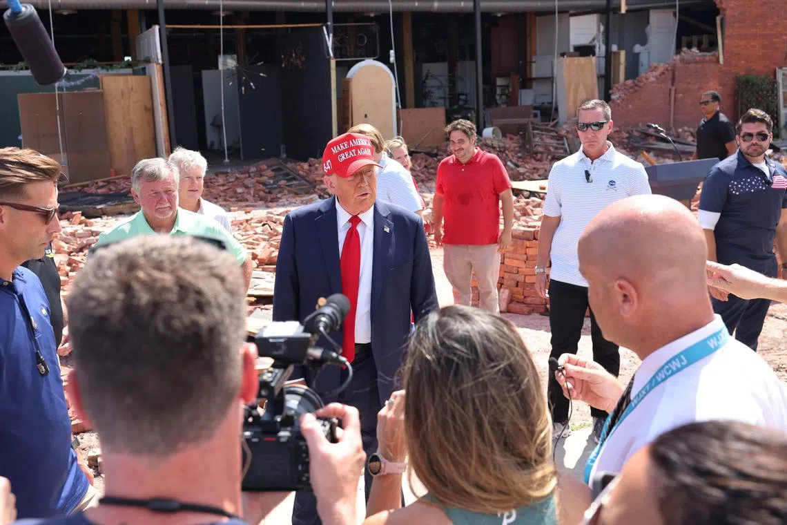 Republican presidential nominee, former US President Donald Trump, speaking with press as he visits Chez What Furniture store which was damaged during Hurricane Helene on Sept 30 in Valdosta, Georgia. 