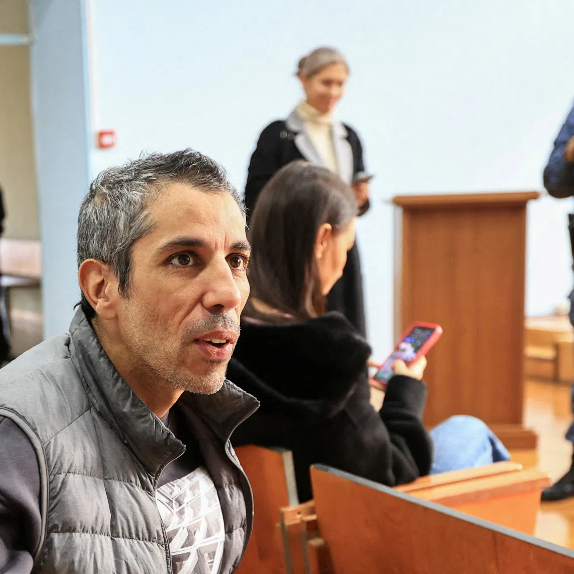 French cyclist Sofiane Sehili, who was found guilty of illegally crossing the Russian border while attempting to break the world record for the fastest cycle crossing of the Eurasian landmass and freed by a court that ordered him to pay a fine, sits in a courtroom in the far eastern settlement of Pogranichniy, Russia, October 23, 2025. REUTERS/Tatiana Meel