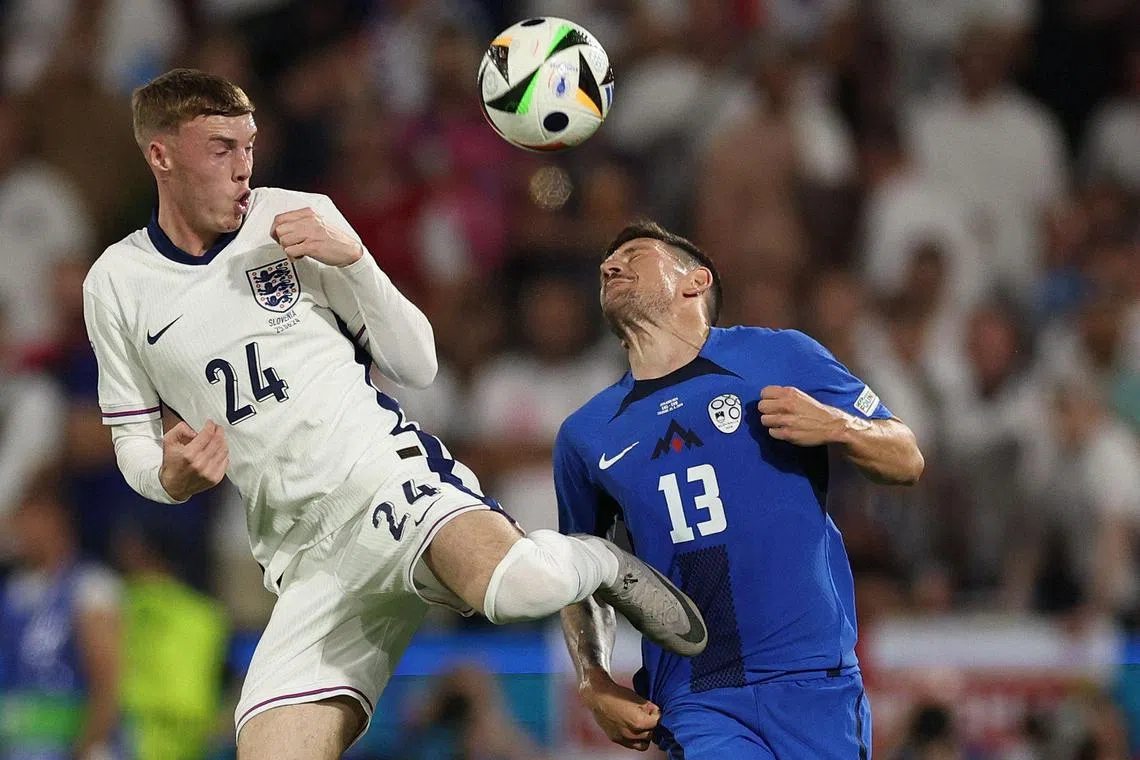 England midfielder Cole Palmer fights for the ball with Slovenia defender Erik Janza.