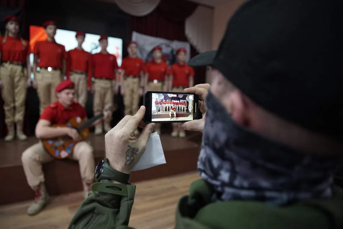 Cadets from the Russian Patriotic Youth Army posing for a photo in a ceremony on Jan 24, where 7-year-old Ivan Ilyin was given a thank you gift by Russian troops.