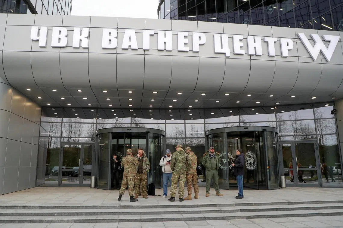 FILE PHOTO: People gather outside PMC Wagner Centre, which is a project implemented by the businessman and founder of the Wagner private military group Yevgeny Prigozhin, during the official opening of the office block in Saint Petersburg, Russia, November 4, 2022. REUTERS/Igor Russak/File Photo