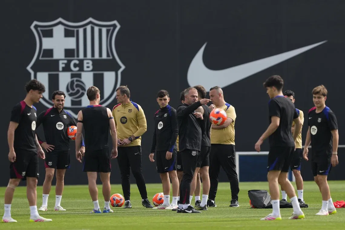 Barcelona coach Hansi Flick giving instructions to his players during a training session.