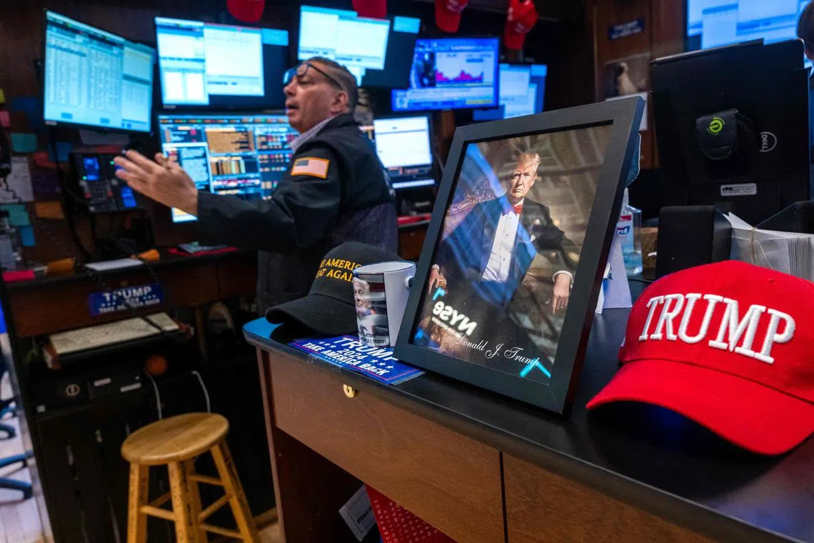 NEW YORK, NEW YORK - DECEMBER 18: A picture of Donald Trump is displayed as traders work on the New York Stock Exchange (NYSE) floor on December 18, 2024 in New York City. The Dow was up almost 200 points in morning trading before the Federal Reserve holds its meeting today on interest rates. Spencer Platt/Getty Images/AFP (Photo by SPENCER PLATT / GETTY IMAGES NORTH AMERICA / Getty Images via AFP)