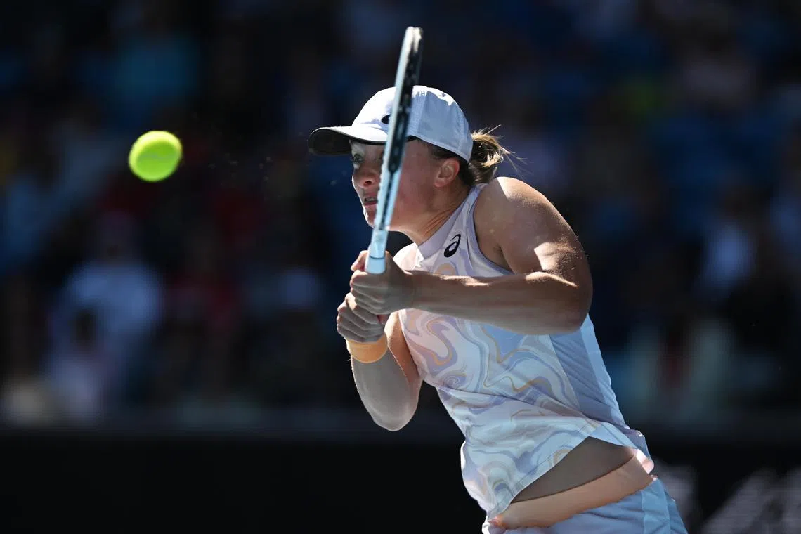 Poland's Iga Swiatek returning to qualifier Cristina Bucsa of Spain in her crushing 6-0, 6-1 third-round win at the Australian Open in Melbourne on Jan 20, 2023.