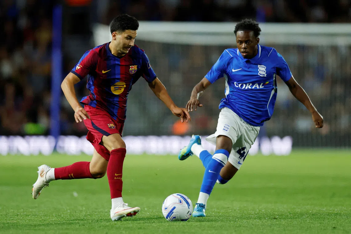 FILE PHOTO: Soccer Football - Pre Season Friendly - Birmingham City v FC Barcelona - St Andrew's @ Knighthead Park, Birmingham, Britain - July 31, 2026 FC Barcelona's Roony Bardghji in action with Birmingham City's Menzi Mazwi Action Images via Reuters/Jason Cairnduff/File Photo