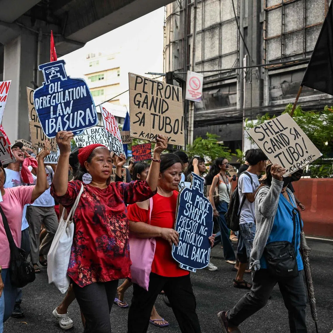Jeepney drivers and consumer advocates hold a rally to protest soaring oil prices that have sunk the peso.