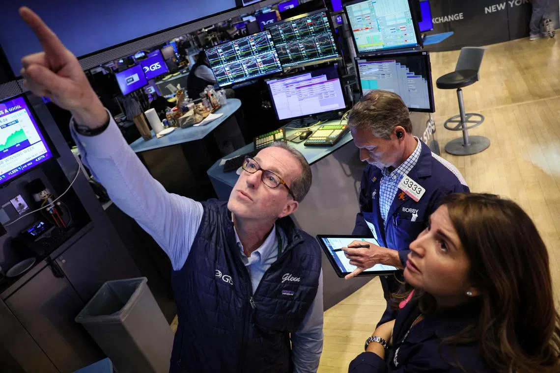 Traders work on the floor of the New York Stock Exchange, in New York City.