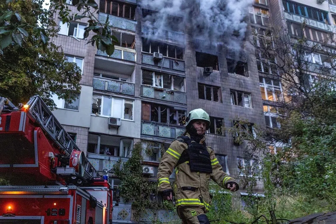 A firefighter working at the site of an apartment building that was hit during Russian missile and drone strikes, amid Russia's attack on Ukraine, in Kyiv, Ukraine, June 15.