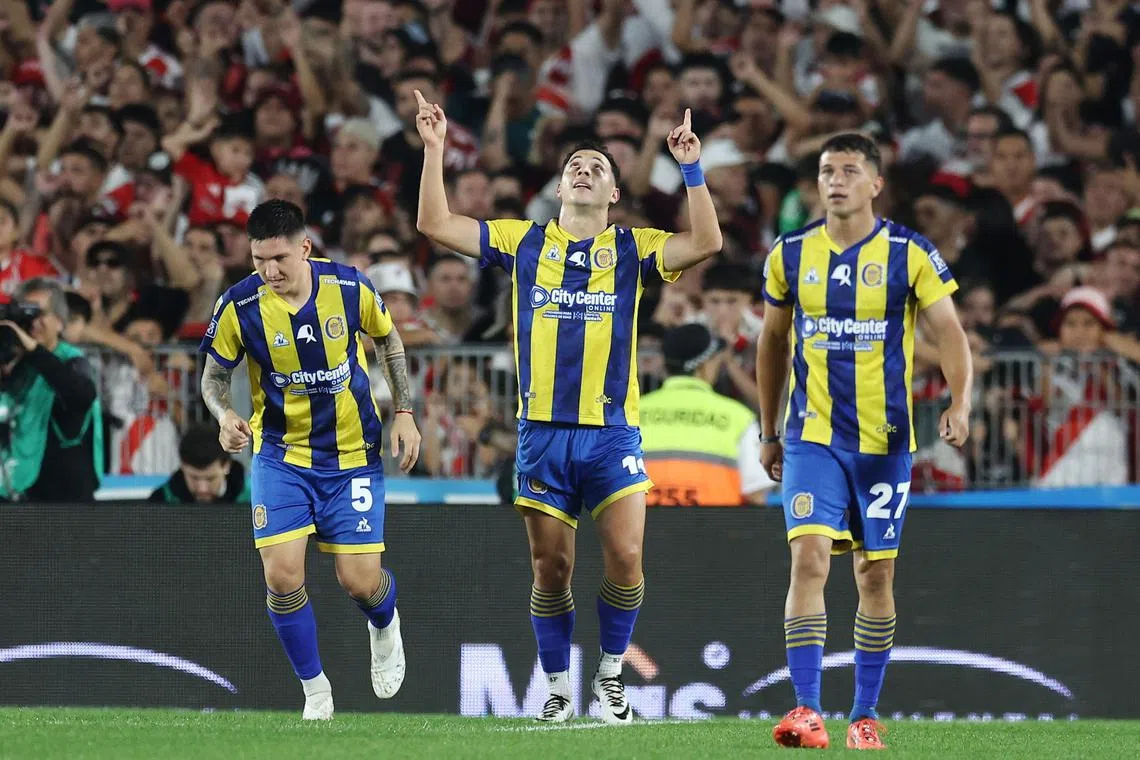 Rosario Central's Paraguayan forward  Sebastian Ferreira celebrates next to midfielder Franco Ibarra (No. 5) and midfielder Gaspar Duarte after scoring his team's first goal in the Argentinian league game against River Plate at Monumental stadium in Buenos Aires on March 29, 2025.