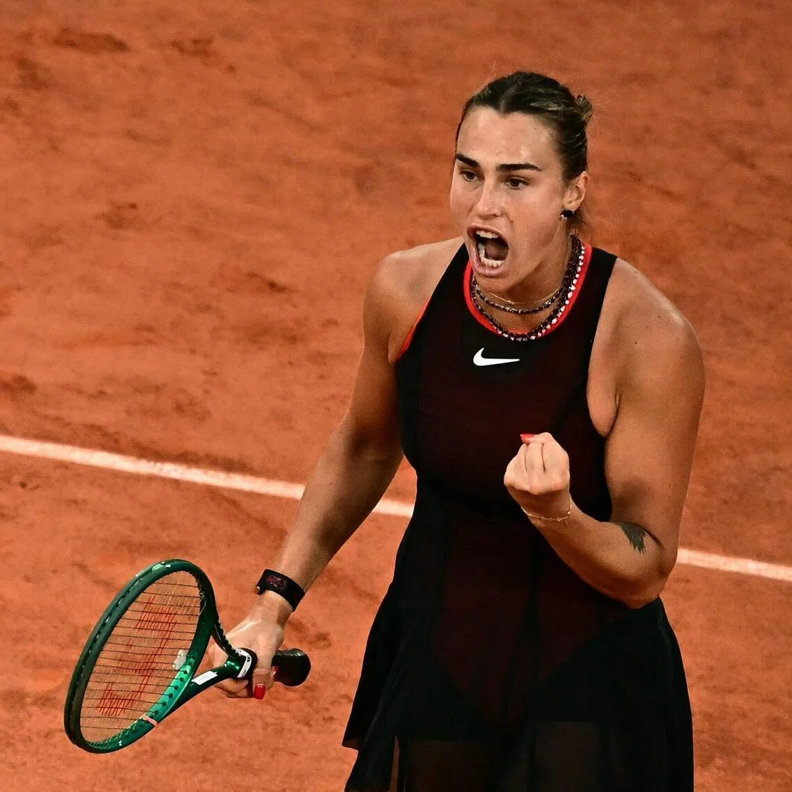 Aryna Sabalenka reacts to a point against Japan's Naomi Osaka during their French Open match.