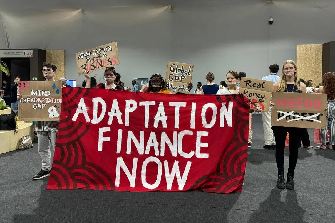 Adaptation Finance Now! protestors onducting a silent demonstration outside a press conference room inside the COP30 Blue Zone.