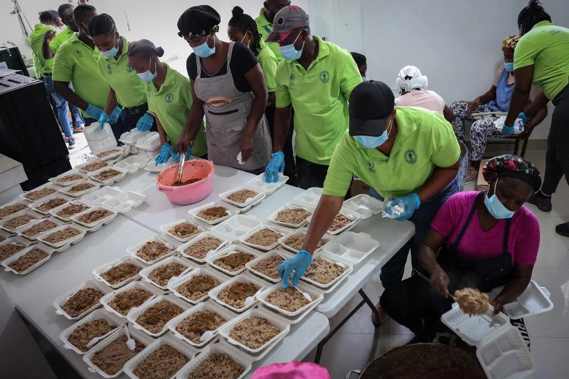 A community action center, with the assistance of the United Nations World Food Programme, prepare hot meals for gang war refugees at Jeunes Filles high school in Port-au-Prince, Haiti, May 3, 2024.  REUTERS/Ricardo Arduengo/File Photo