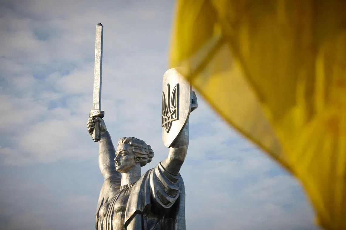 A Ukrainian national flag waves in front of the 'Motherland' monument during a rising ceremony of Ukraine's biggest national flag to mark the Day of the State Flag, amid Russia's attack on Ukraine, in Kyiv, Ukraine August 23, 2023. Ukrainian Presidential Press Service/Handout via REUTERS ATTENTION EDITORS - THIS IMAGE HAS BEEN SUPPLIED BY A THIRD PARTY.
