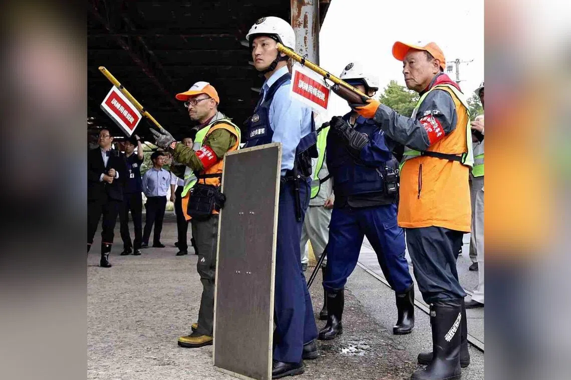 Hunting association members and police officers train to confront bears in an "emergency hunting" program in Tendo, Yamagata Prefecture, on Sept 25.