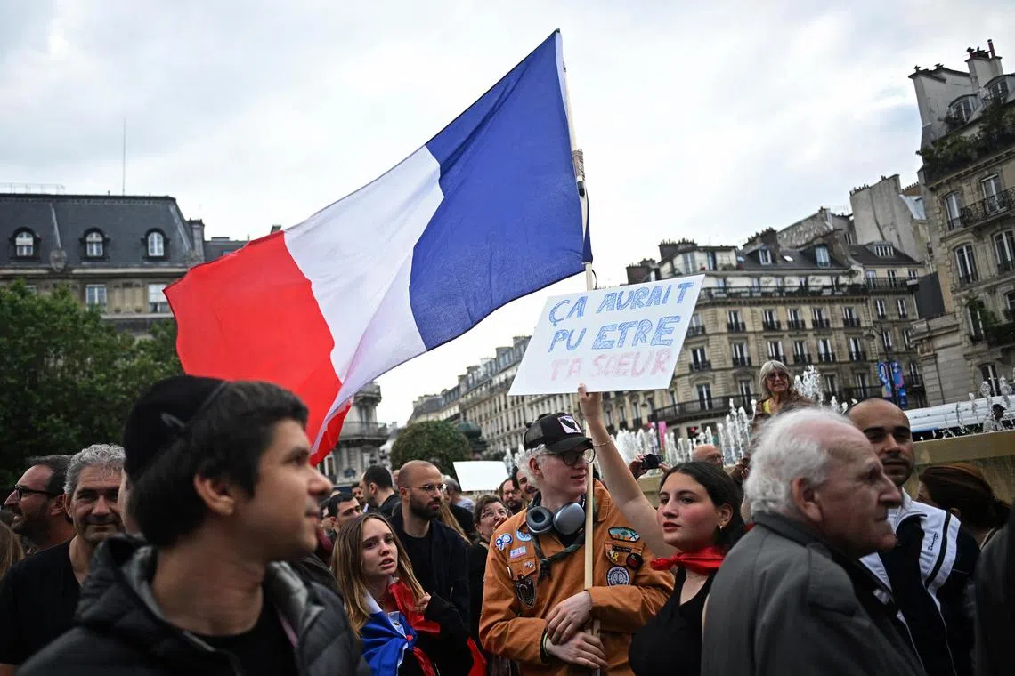 A protester holds a sign reading, "It could have been your sister," at a demonstration in Paris over the gang-rape of a 12-year-old Jewish girl.