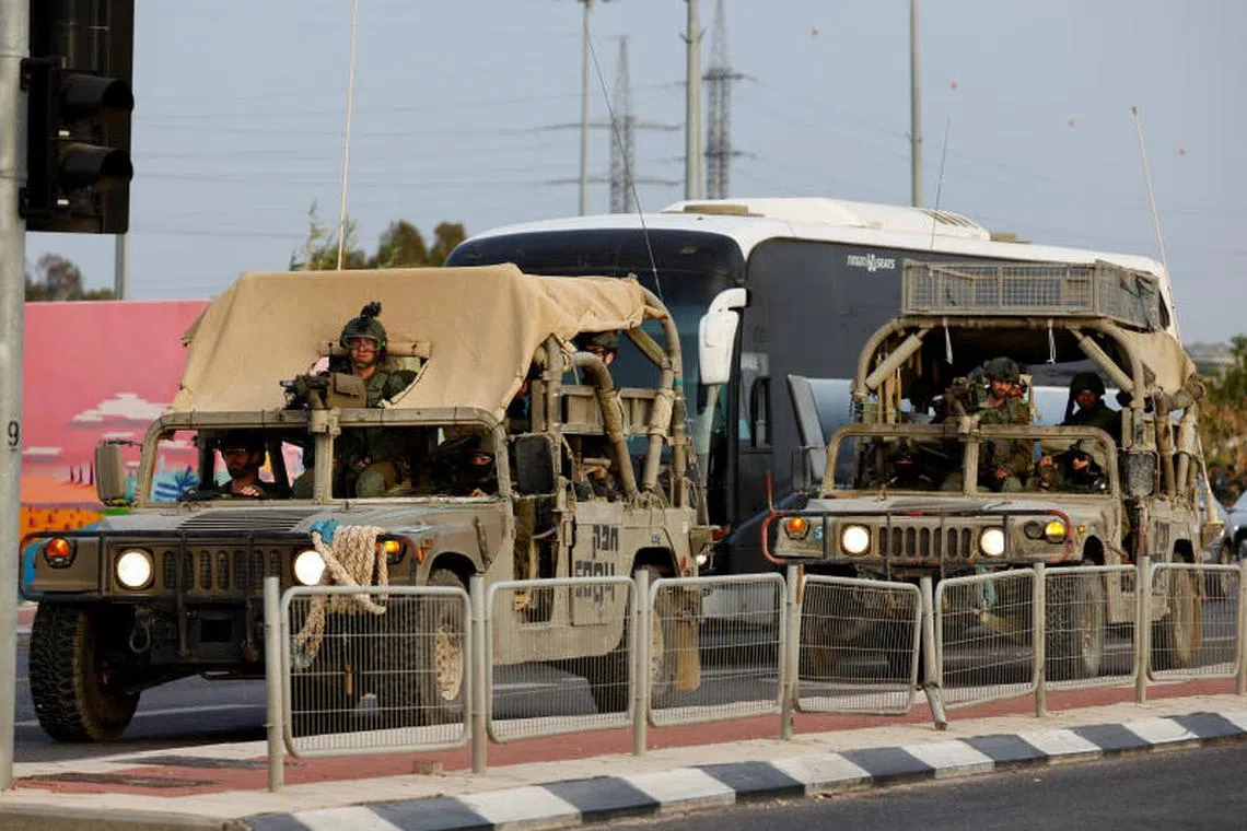 Israeli military jeeps drive near the city of Sderot, Israel, on May 18.
