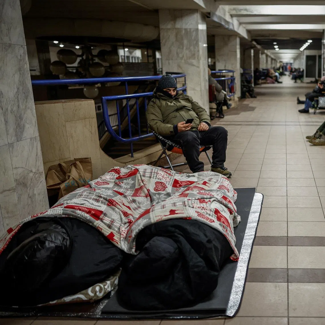 People take shelter inside a metro station during a Russian missile and drone strike in Kyiv, where temperatures have hovered below 0 deg C, on Jan 20.