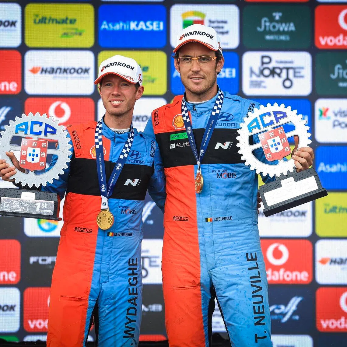 Thierry Neuville (right) and his co-pilot Martijn Wydaeghe celebrate after winning the Portugal Rally, as part of the World Rally Championship (WRC) in Fafe on May 10, 2026.