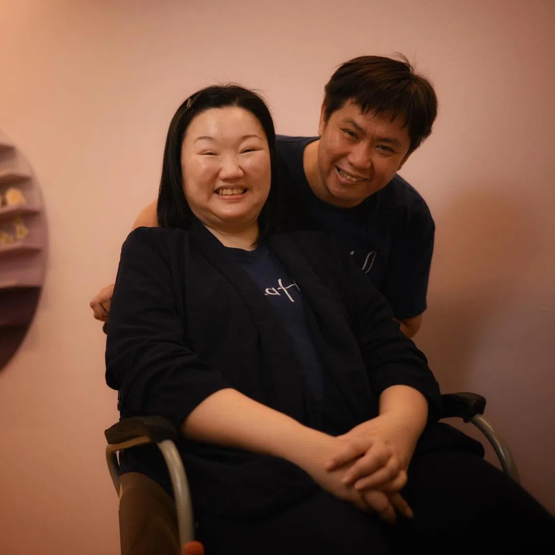 Huang Jing Han (left) was diagnosed with ALS in 2017, two years after she began experiencing symptoms such as slurred speech and difficulty walking down the stairs. /ALS patient Huang Jing Han (left) shares a tender moment with her husband Fabian Tan on July 14, 2026ST20260714_202698000148 juals Chong Jun Liang