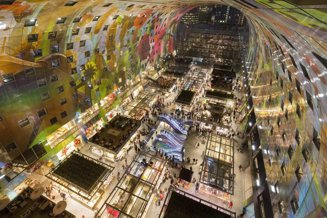 The Markthal in Rotterdam, a sustainably designed mixed-use complex, features privately developed apartments in a massive arched structure,